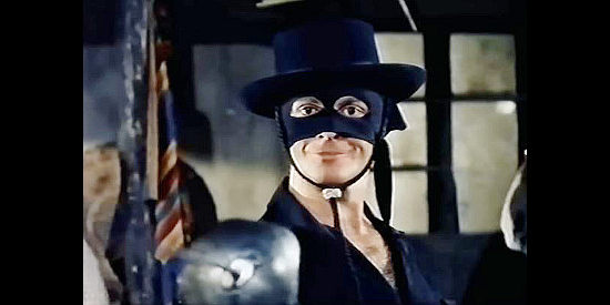 Guy Stockwell as Zorro, smiling maniacally as he prepares to dole out vengeance to the governor's soldiers in Sword of Zorro (1963)