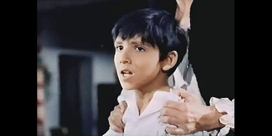 Julio Cesar as young Diego, watching in horror as government troops force their way into his home in their search for Zorro in Sword of Zorro (1963)
