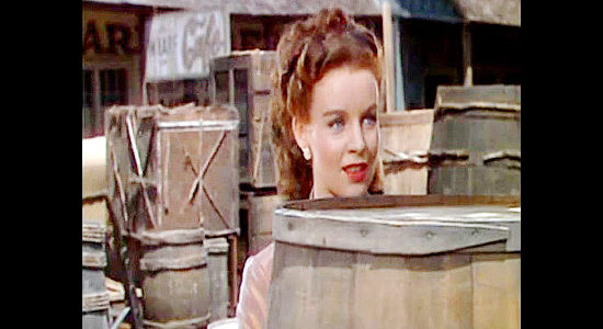 Helena Carter as Stephanie Morrison, getting a peek a the loggers as they race toward town and a good time in River Lady (1948)