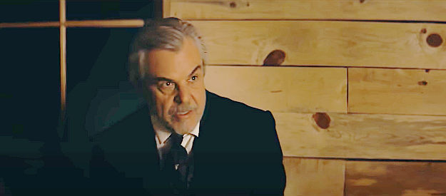 Danny Huston as Rudolph Schiller, mayor of Elk Flats, conspiring with Alfred Jeffries to capitalize on a silver strike near town in The Dead Don't Hurt (2023)
