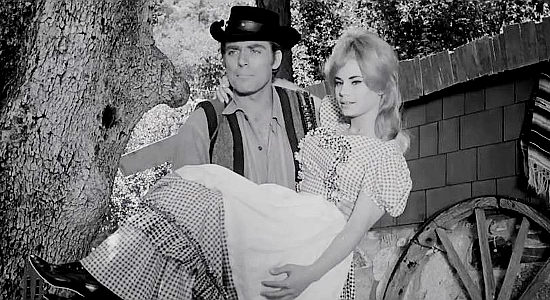 Ross Hagen as Justin Kane, declaring Abigail pretty as a whole flock of canaries in Mark of the Gun (1969)