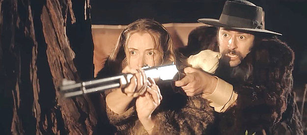 Sydney Van Delft as Mabeline Barley, helping Wesley Hart (Michael Fredianelli) take aim at enemies in The Perfect Hand (2003)