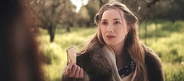 Sydney Van Delft as Mabeline Barley, showing off the treasure map she's managed to steal from her father in The Perfect Hand (2023)