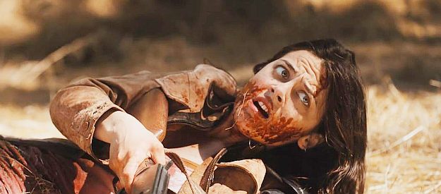 Deena Ingley as Delilah Sorrow, badly wounded but still fighting the bad guys in Once Upon a Time in the Wasteland (2022)