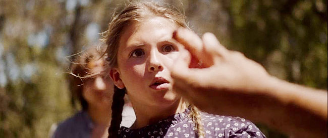 Jaqueline McNulty as young Cynthia Long, being shown one of her dad's severed fingers in Coyote Woman (2024)