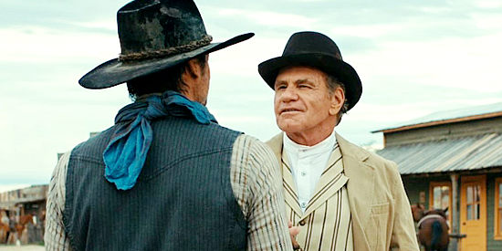 Martin Kove as Ambrose Masse talking to Hunter Braddock about a town's bright future, for those who play their cards right, in Far Haven (2023)