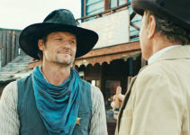 Bailey Chase as Hunter Braddock, getting a lesson in a town's future from Ambrose Masse (Martin Kove) in Far Haven (2023)