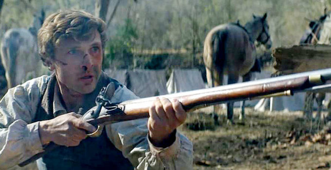 William Moseley as Davy Crockett, taking a shot at the man trying to destroy his family in The Ballad of Davy Crockett (2024)