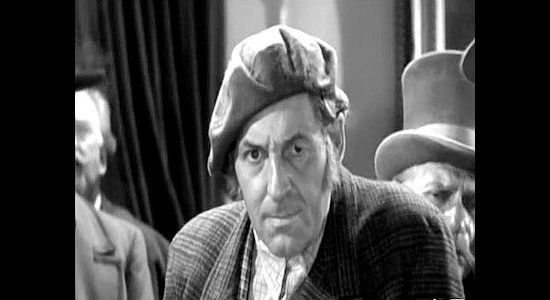 Roger Gray as Sandy Ferguson, outraged over the way friend Sawbuck McTavish is cheated at the Bella Donna in Barbary Coast (1935)