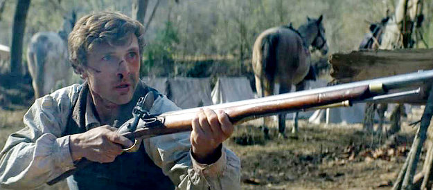 William Moseley as Davy Crockett, taking a shot at the man trying to destroy his family in The Ballad of Davy Crockett (2024)