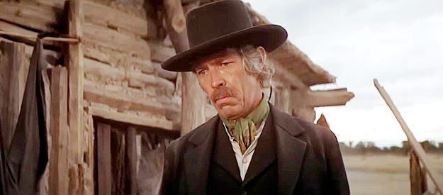 James Coburn as Pat Garrett, looking down at the body of his latest kill in Pat Garrett and Billy the Kid (1973)