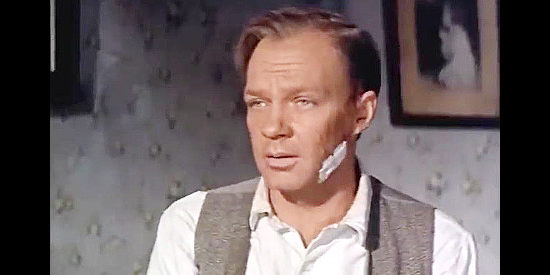 Jamie Uys as Ernie Dobbs, a storekeeper more inclined to flee than stand up to the Billings clan in The Hellions (1961)