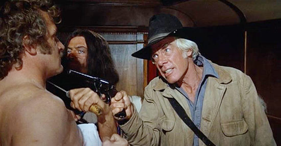 Lee Marvin as Sam Longwood, threatening boxer Vishniac (Howard Platt) along with Joe Knox (Oliver Reed) in The Great Scout and Cathouse Thursday (1976)