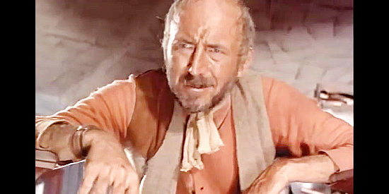 Lionel Jeffries as Luke Billings, searching the general store for his son Mark in The Hellions (1961)