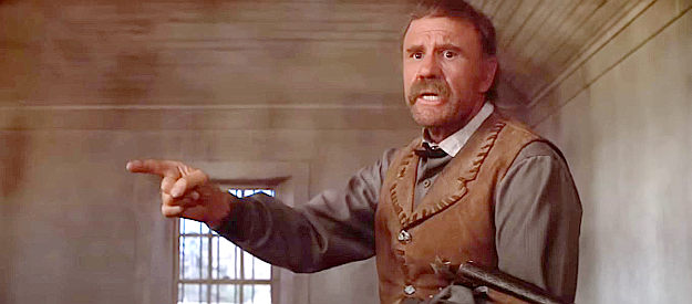 R.G. Armstrong as Ollinger, preaching fear of the Lord to prisoner Billy the Kid in Pat Garrett and Billy the Kid (1973)