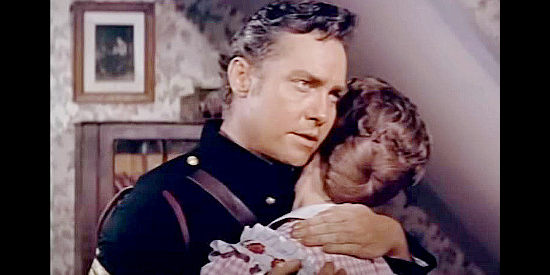 Richard Todd as Sgt. Sam Hargis, embracing his wife before a showdown with the Billings clan in The Hellions (1961)