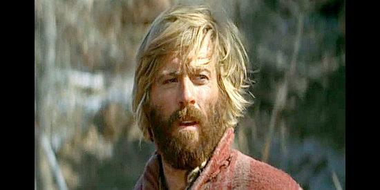 Robert Redford as Jeremiah Johnson, adjusting to life in the wilderness in Jeremiah Johnson (1972)