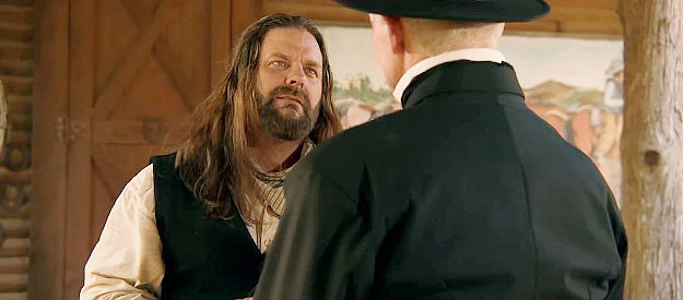 James Storm as Jack Sullivan, an informant for the Bridle brothers, threatening Pastor Willingham in Doc Holliday (2023)