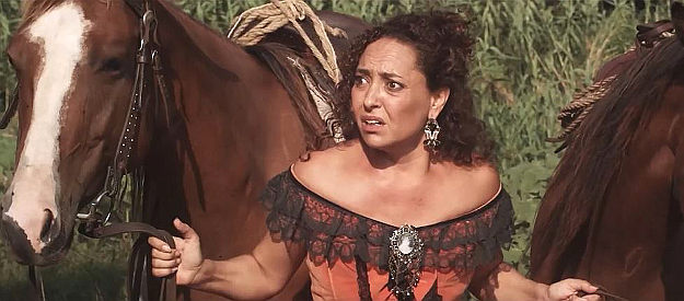 Micaela Sanngermano as Estrella, Chavez's lover, holding horses for his getaway in The Dutchman (2020)