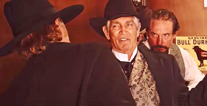 Eric Roberts as Arlis Blackthorn, Caleb Wilkenson's hired gun, confronted by A. Pettigrew (Davy Williams) and Beau Boone (Shane Clouse) in Mr. Pettigrew (2024)