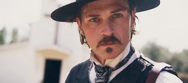 Tom Zembrod as Doc Holliday, staring down an adversary in a gunfight in Doc Holliday (2023)