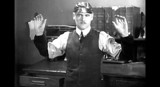 Edward Hearn as Frank Edwards, the bank clerk, about to make a risky decision in Hell's Heroes (1929)