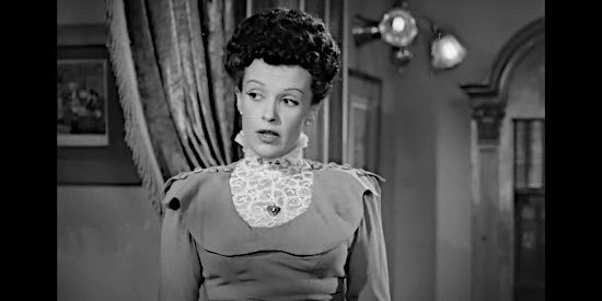 Eve Lynne as Martha, Tito Morell's secretary in Flame of the Barbary Coast (1945)