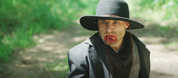 J. Benedict Larmore as Emmett Dalton, a bit bloodied after a run-in with Chris Madsen in The Guardsmen II (2024)