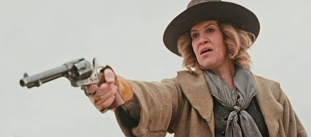 Lena Wilcox as Gretchen, a member of the outlaw gang, holding up a stagecoach in Ghosts of Red Ridge (2024)