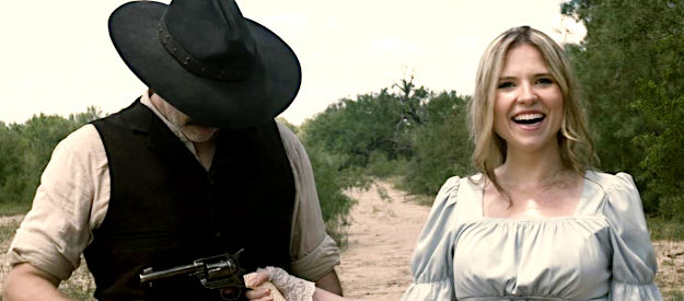 Nicole Mattox as Ellie returning a six-gun to George Newcomb after a shooting scrap in Lady Outlaw (2024)