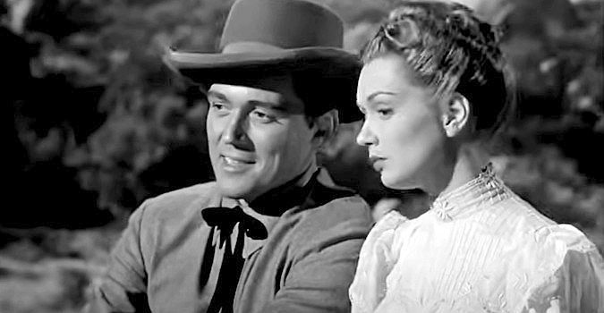 William Bishop as Bill Foss and Gloria Henry as Jeannie Manning on a stagecoach ride in Adventures in Silverado (1948)