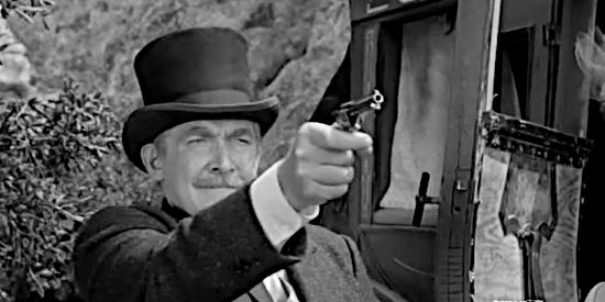 Roy Roberts as Matt Quigg, firing a shot at a stagecoach holdup bandit in Yaqui Drums (1956)