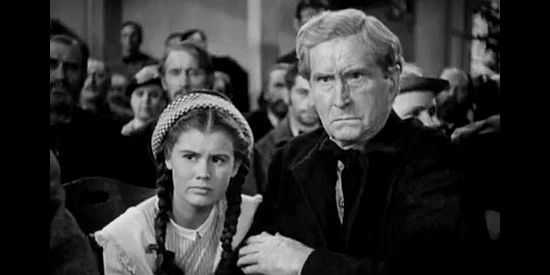 Betty Brewer as Janey and Russell Simpson as Ned Nolan, listening to testimony at his trial in Wild Bill Hickok Rides (1942)