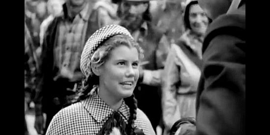 Betty Brewer as Janey, thrilled for a reunion with Wild Bill, one of her adopted dads in Wild Bill Hickok Rides (1942)