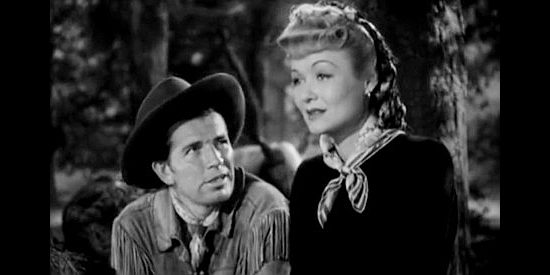 Bruce Cabot as Wild Bill Hickok, distracted by Belle Andrews (Constance Bennett), just as Farrel intended, in Wild Bill Hickok Rides (1942)