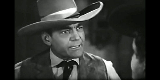 Buck Jones as Sheriff Jim McDaniels, a lawman in cahoots with outlaw Tom Cook in Wagons Westward (1940)