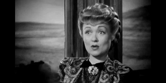 Constance Bennett as Belle Andrews, surprised to learn she and Wild Bill have the same destination in Wild Bill Hickok Rides (1942)