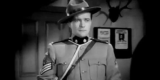 Dennis Morgan as Sgt. Derry Conniston, getting orders to track down John Keith in River's End (1940)