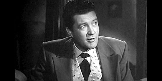 Dennis Morgan as gambler James Wylie, being talked into helping Wells Fargo search for The Poet in Cheyenne (1947)