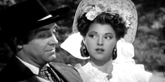 Diana Barrymore as Claire, trying to figure out the intentions of Steve Logan (Robert Paige) in Frontier Badmen (1943)