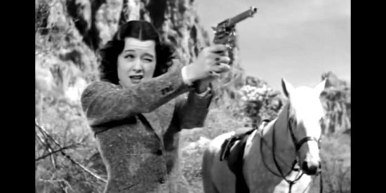 Ellen Drew as Ellen Dangerfield, practicing her shooting on her return to Texas in Texas Rangers Ride Again (1940)