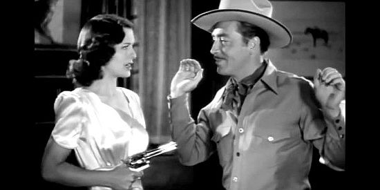 Ellen Drew as Ellen Dangerfield, with the man she thinks is Pecos Bill (John Howard) under her gun in Texas Rangers Ride Again (1940)