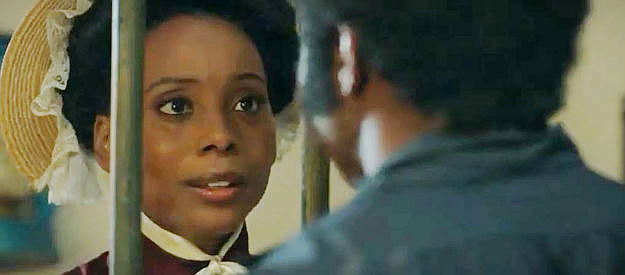 Erica Ash as Bessie Lee, visiting Johnny Black in jail as he faces a hangman's noose again in Outlaw Johnny Black (2023)