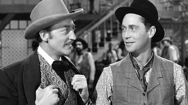 Franchot Tone as Tim 'Kansas' Mason with Dawson (Warren Williams), the man he suspects of being behind the trouble in Trail of the Vigilantes (1940)