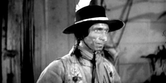 Frank Lackteen as Cherokee, a Prentice rider and expert knife thrower, about to practice his skill in Frontier Badmen (1943)