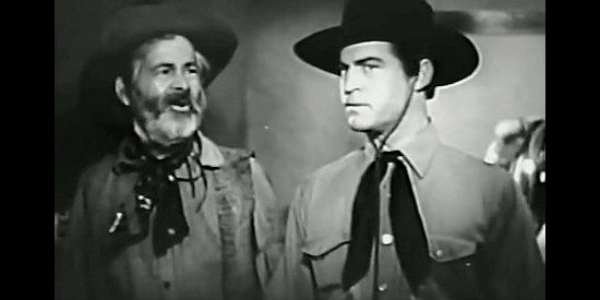 George 'Gabby' Hayes as Hardtack, wondering how good twin David Cook (Chester Morris) is going to convince folks he's bad twin Tom Cook in Wagons Westward (1940)