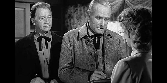 George Macready (center) as Marshal Sam Hughes, pretending to be a census taker to get information out of Elaine in The Doolins of Oklahoma (1949)