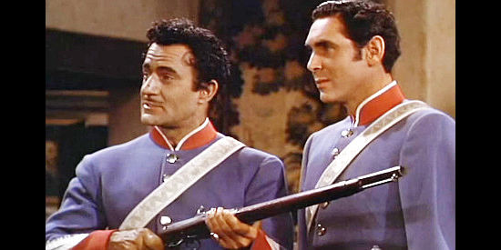 Gilbert Roland as Maj. de Rojas and Phillip Reed as Lt. Carlos Ortega, inspecting the guns Kent has delivered in Pirates of Monterey (1947)