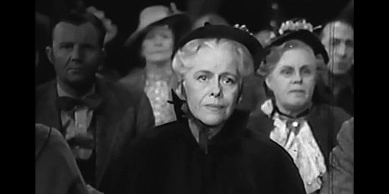 Janet Beecher as Mrs. Tweedy, housekeeper at the parish home, listening to trial testimony in The Parson of Panamint (1941)