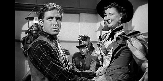 Jock Mahoney as Tulsa Jack Blake, his attention diverted from the young lady he's entertaining in The Doolins of Oklahoma (1949)